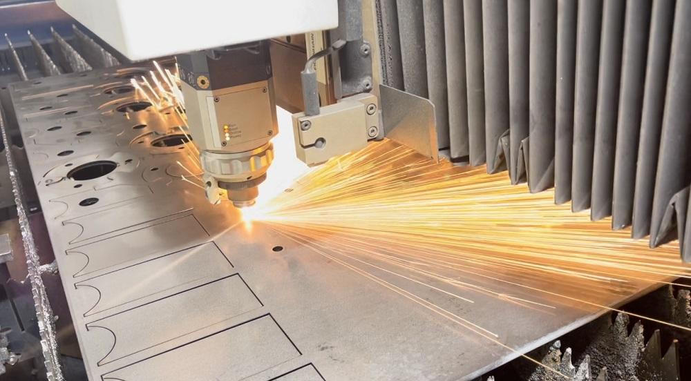 Industrial laser cutting metal with sparks